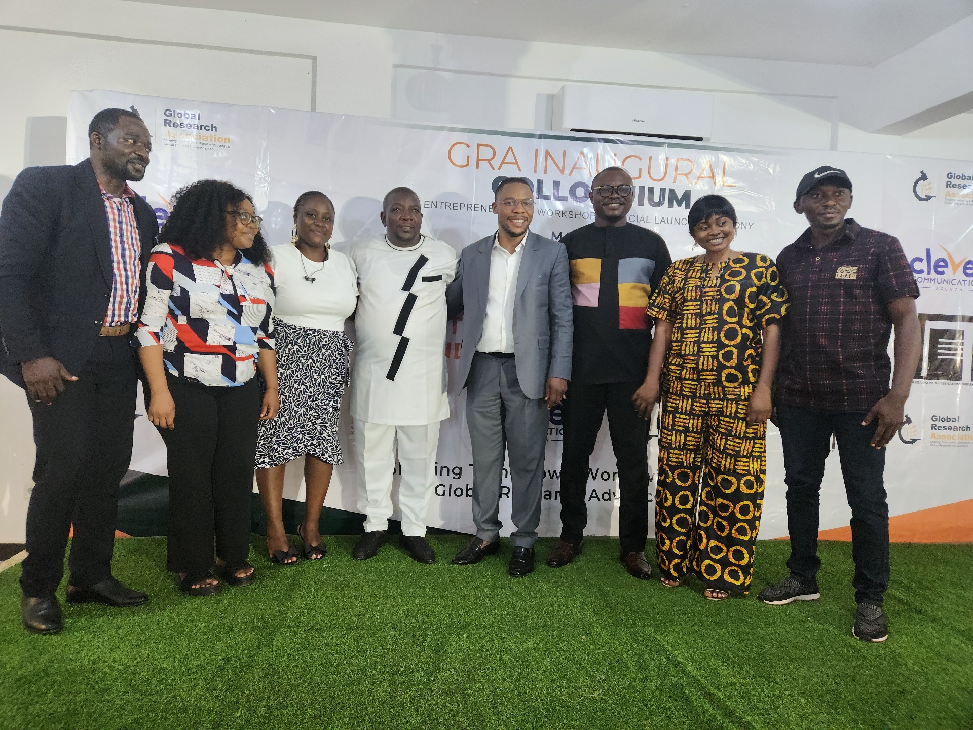 GRA Inaugural Colloquium — group photo with partners in front of event banner