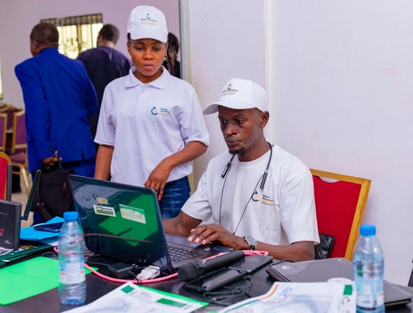 GRA team members preparing the registration and tech desk in Yaoundé ahead of the Inaugural Colloquium