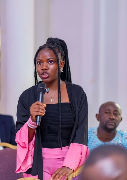 Colloquium participant standing with a microphone to ask a question during a Q&A session at the GRA Inaugural Colloquium