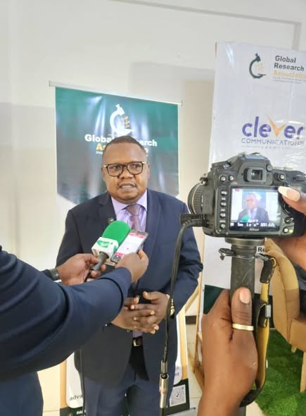 GRA representative interviewed by journalists with microphones in front of GRA and Clever Communications banners